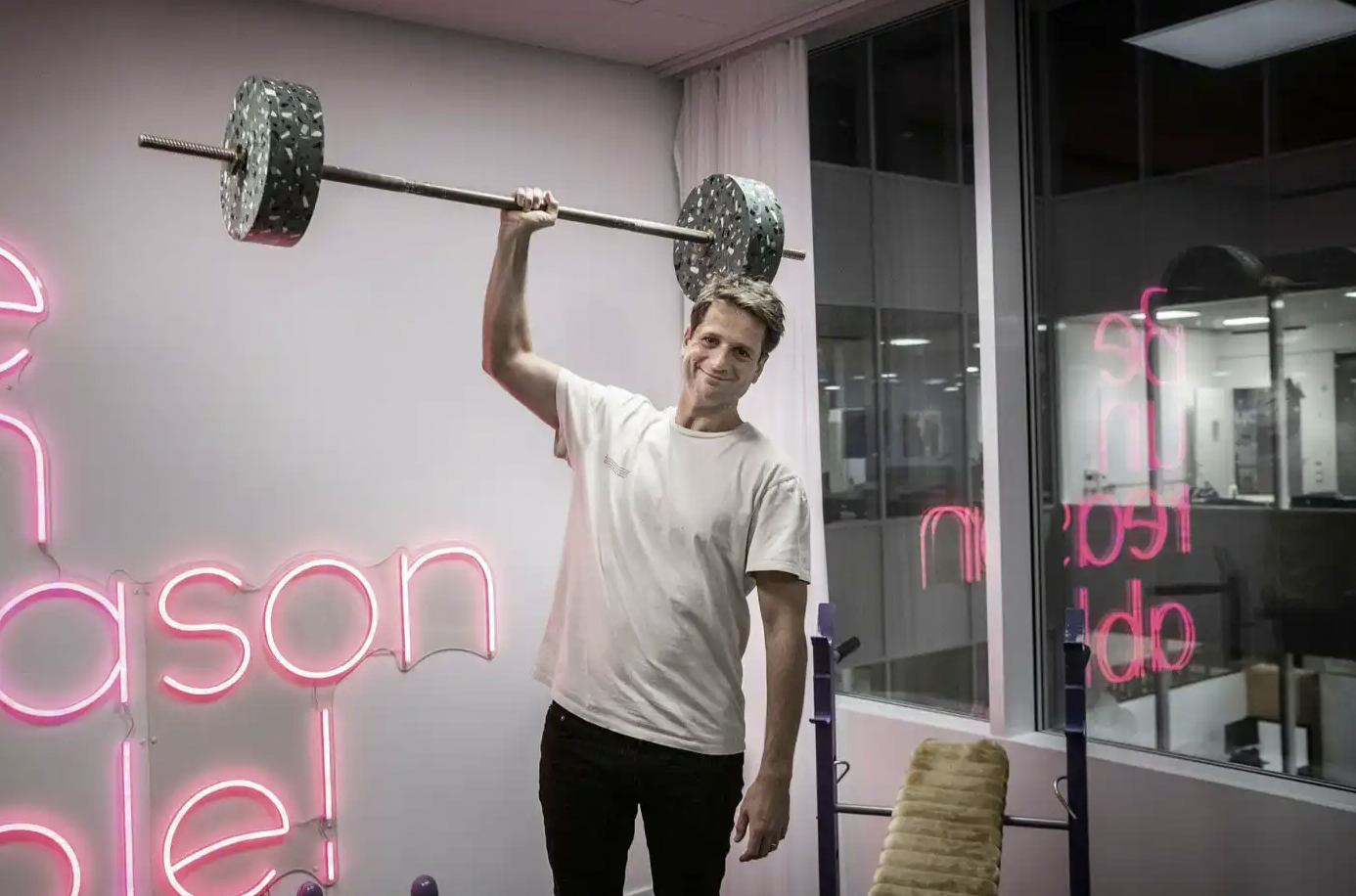 Photo of Sebastian Siemiatkowski holding a large dumbbell with only one hand.